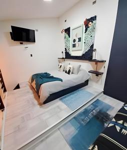 a bedroom with a bed and a flat screen tv at 2 Family Lofts + central heating + comfort in Coihaique