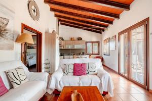 a living room with a white couch and a table at Petit Son Bauló in Can Picafort