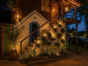 a building with a staircase with plants and lights at Vila Maré Alta Caraiva in Caraíva +13 photos