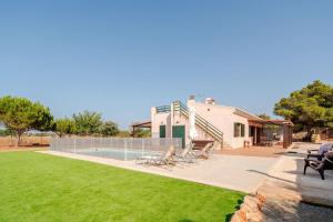 a house with a yard with a swimming pool at Petit Son Bauló in Can Picafort