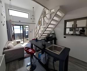 a living room with a staircase and a couch at Comfort, Innovation, Style, WiFi, Gym in Coihaique