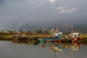 a group of boats docked in a body of water at Comfort, Innovation, Style, WiFi, Gym in Coihaique +11 photos