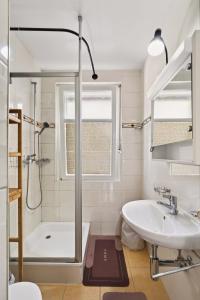 a bathroom with a shower and a tub and a sink at Charming city in Lausanne +14 photos