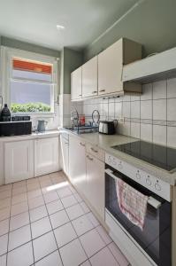 a kitchen with white appliances and a window at Charming city in Lausanne