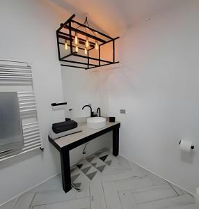 a bathroom with a sink and a chandelier at 6 Universal Access Comfort WiFi central heating in Coihaique