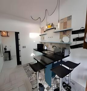 a kitchen with black tables and chairs in a room at 6 Universal Access Comfort WiFi central heating in Coihaique