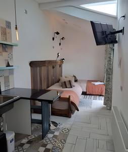 a bedroom with a bed and a desk and a television at 6 Universal Access Comfort WiFi central heating in Coihaique