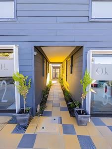 a hallway of a building with potted plants at 6 Universal Access Comfort WiFi central heating in Coihaique