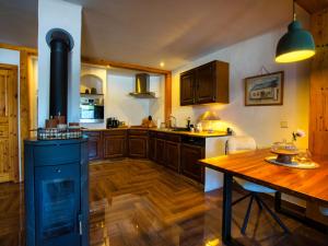 a kitchen with a stove and a wooden table at Ferienwohnung Cozy Cottage in Morbach