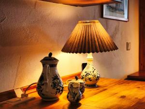 two vases sitting on a table with a lamp at Ferienwohnung Cozy Cottage in Morbach +12 photos