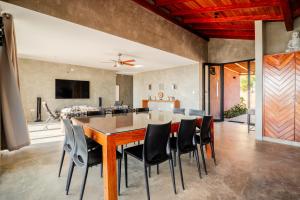 a dining room and living room with a table and chairs at La Morada Punta Sal - Casa de playa frente al mar in Canoas de Punta Sal +42 photos