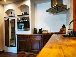 a kitchen with wooden cabinets and a counter top at Ferienwohnung Cozy Cottage in Morbach