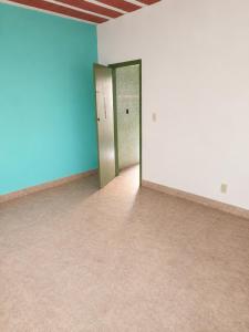 an empty room with blue and white walls and doors at Villa Santa Terezinha in Mesquita +5 photos