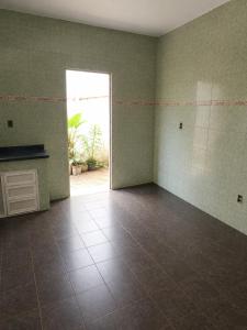 an empty room with a door and a tile floor at Villa Santa Terezinha in Mesquita