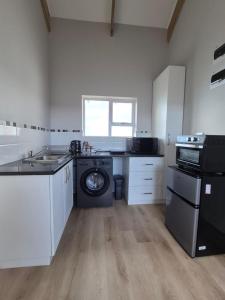 a kitchen with a washing machine and a dishwasher at Guests at 32 Nautilus Bay in Dana Bay