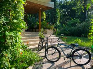 two bikes parked in front of a house at Con Amor Caribe - New 240 sqm Villa & Private Pool in Puerto Viejo