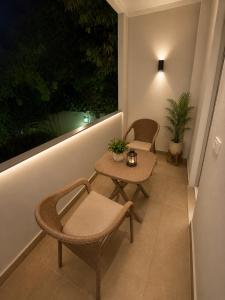 a balcony with two chairs and a table and a window at Royal Moses Pyramids View Hotel in Cairo