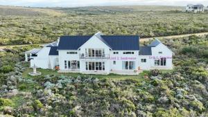 an aerial view of a white house with a garage at Guests at 32 Nautilus Bay in Dana Bay