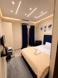 a bedroom with a bed with a towel on it at Royal Moses Pyramids View Hotel in Cairo
