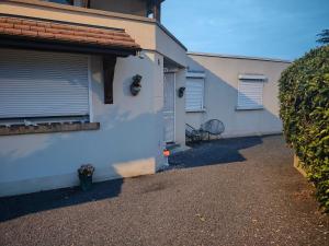 a side view of a house with a garage at Studio chez Fred et Angela in Saint-Dizier