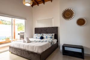 a bedroom with a large bed with a mirror on the wall at Rooftop Penthouse Jacuzzi, 2 Pools Playa Popy 500m in Las Terrenas +36 photos