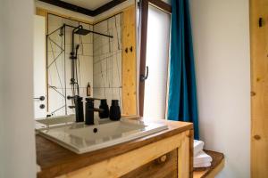 a bathroom with a sink and a mirror at K-Home in Stănija +29 photos