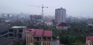 a group of buildings in a city in the rain at Apartament in Batumi