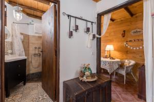 a bathroom with a sink and a toilet and a table at Casa Fuente Hervera in Vega de San Mateo +37 photos