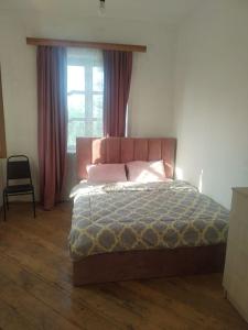 a bedroom with a bed and a window at Farmer's Guest House in Telavi +33 photos