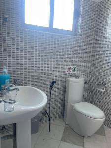 a bathroom with a toilet and a sink at Serenade Beach in Durrës