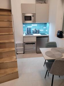 a kitchen with a table and a microwave at BEM MINI STUDiO in Budapest