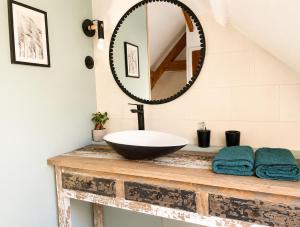 a bathroom with a sink and a mirror on a counter at maison cosy centre ville in Ham +6 photos