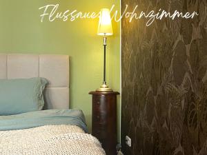 a bedroom with a lamp next to a bed at Havelzeit in Havelberg