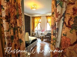 a bedroom with curtains and a bed in a room at Havelzeit in Havelberg