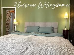 a bedroom with a bed with a sign on the wall at Havelzeit in Havelberg
