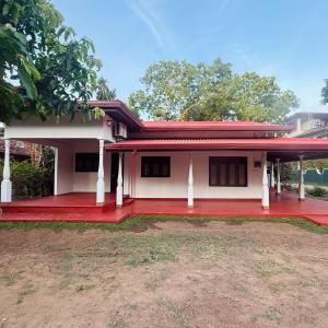 a house with a red floor and a red roof at Yalora Villa Kataragama in Kataragama