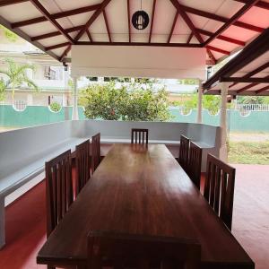 a dining room with a wooden table and chairs at Yalora Villa Kataragama in Kataragama