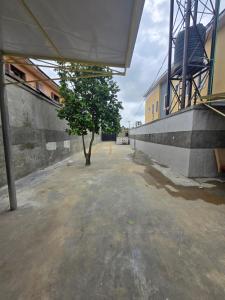 a tree sitting in the middle of a building at Virginhomes apartment in Jibowu +6 photos