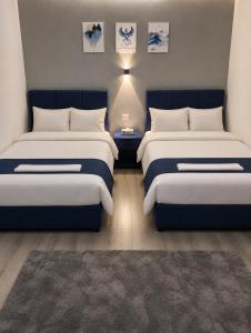 a room with two beds and a rug at Royal Moses Pyramids View Hotel in Cairo +12 photos
