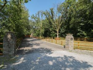 a person walking on a bridge over a fence at Annexe Meadows Farm in Swansea