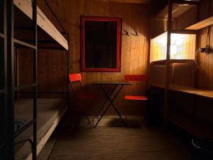 a room with a table and two chairs in a cabin at Basecamp Brno in Brno +9 photos