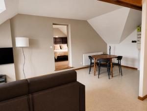a living room with a couch and a table at La Clef des vignes 4 in Roye