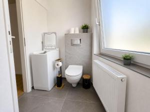 a small bathroom with a toilet and a window at Zum Rheinberg Balcony Suite in Braubach +26 photos