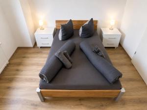 a bed in a room with two night stands at Zum Rheinberg Balcony Suite in Braubach