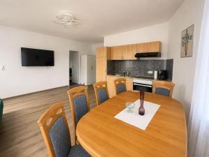 a kitchen and dining room with a wooden table at Zum Rheinberg Balcony Suite in Braubach