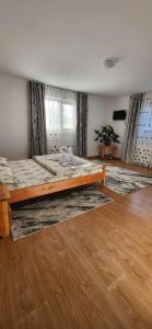 a bedroom with a large bed in a room at Casa Răzvan in Arieşeni