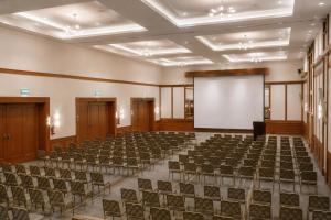 an empty hall with a white screen and chairs at Locanda Punta Del Este in Punta del Este +43 photos