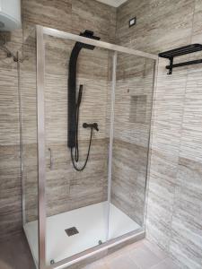 a shower with a black hose in a bathroom at Oasi Villa Giusy in Capoterra +11 photos