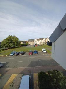a parking lot with cars parked in a parking lot at The Rosewood in Grays Thurrock