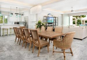 a dining room and kitchen with a table and chairs at Moringa Villa in Long Bay Hills